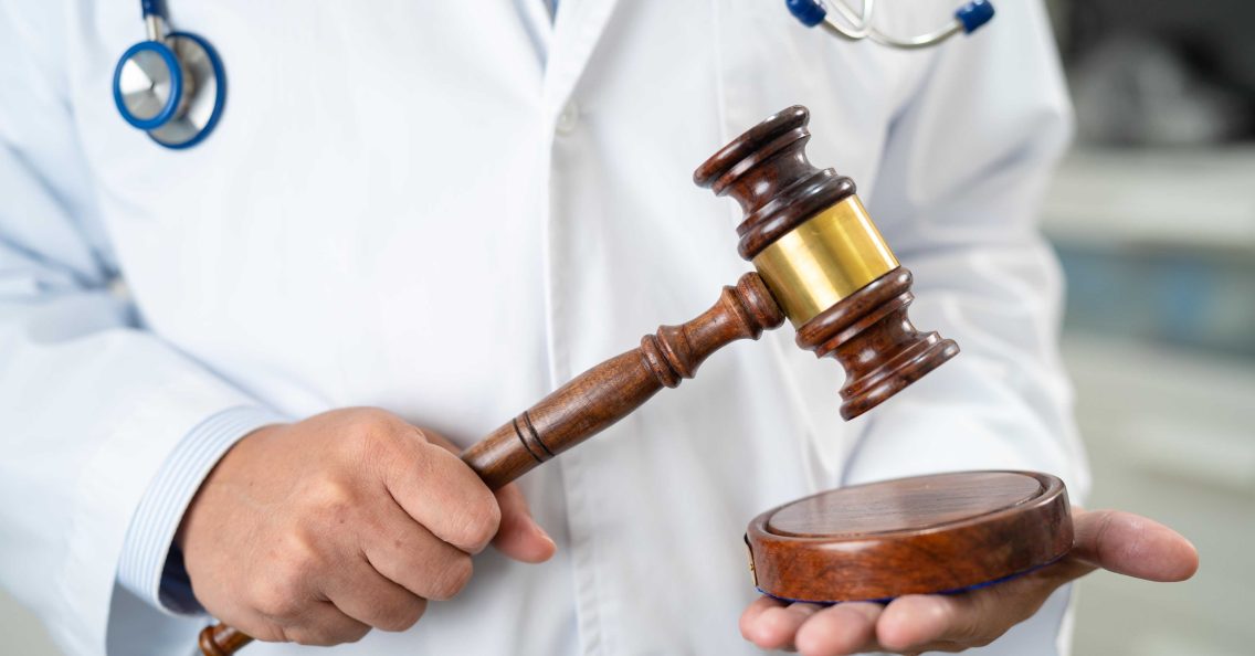 doctor holding a judge gravel