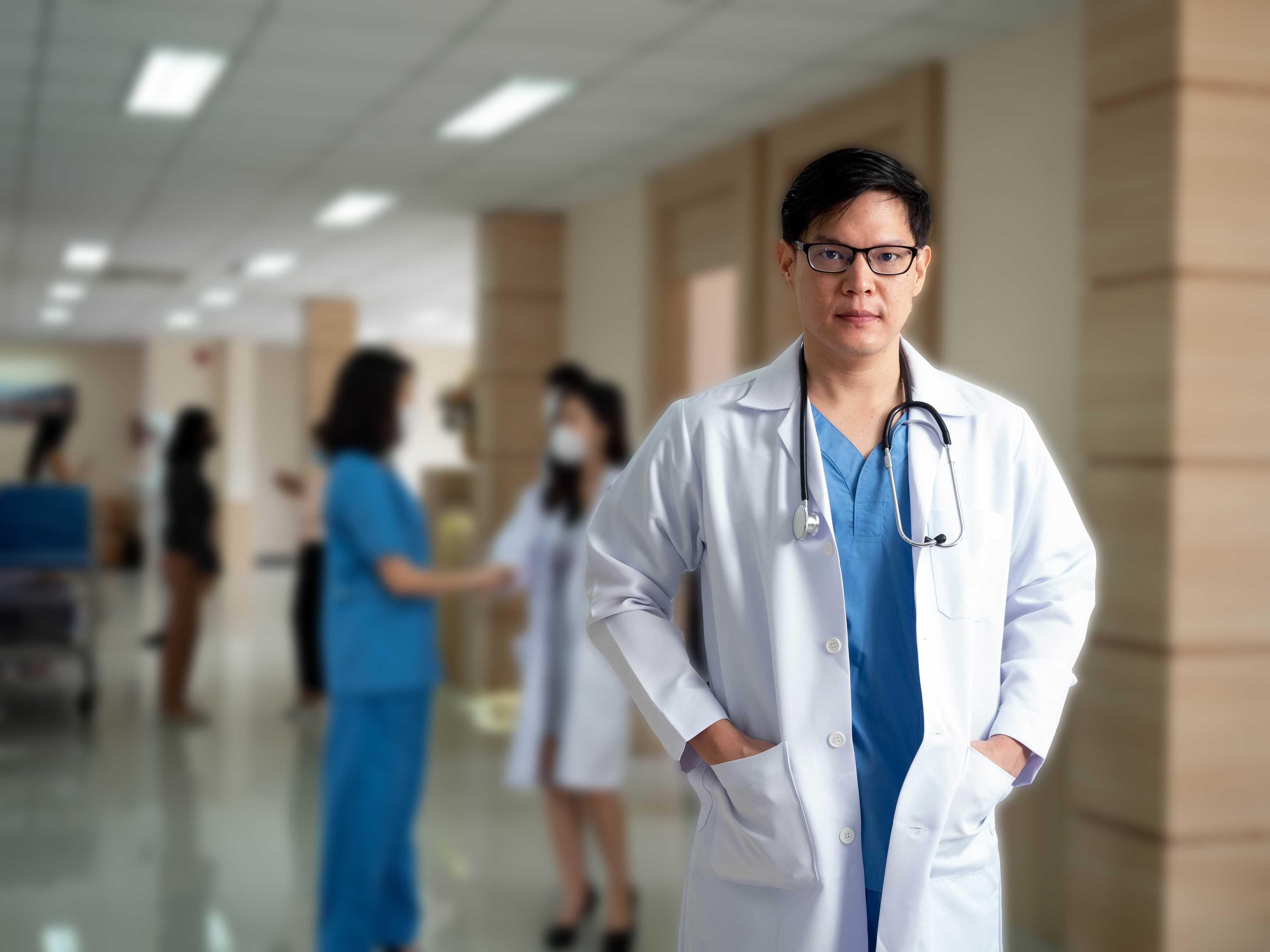 male doctor standing in hallway of hospital