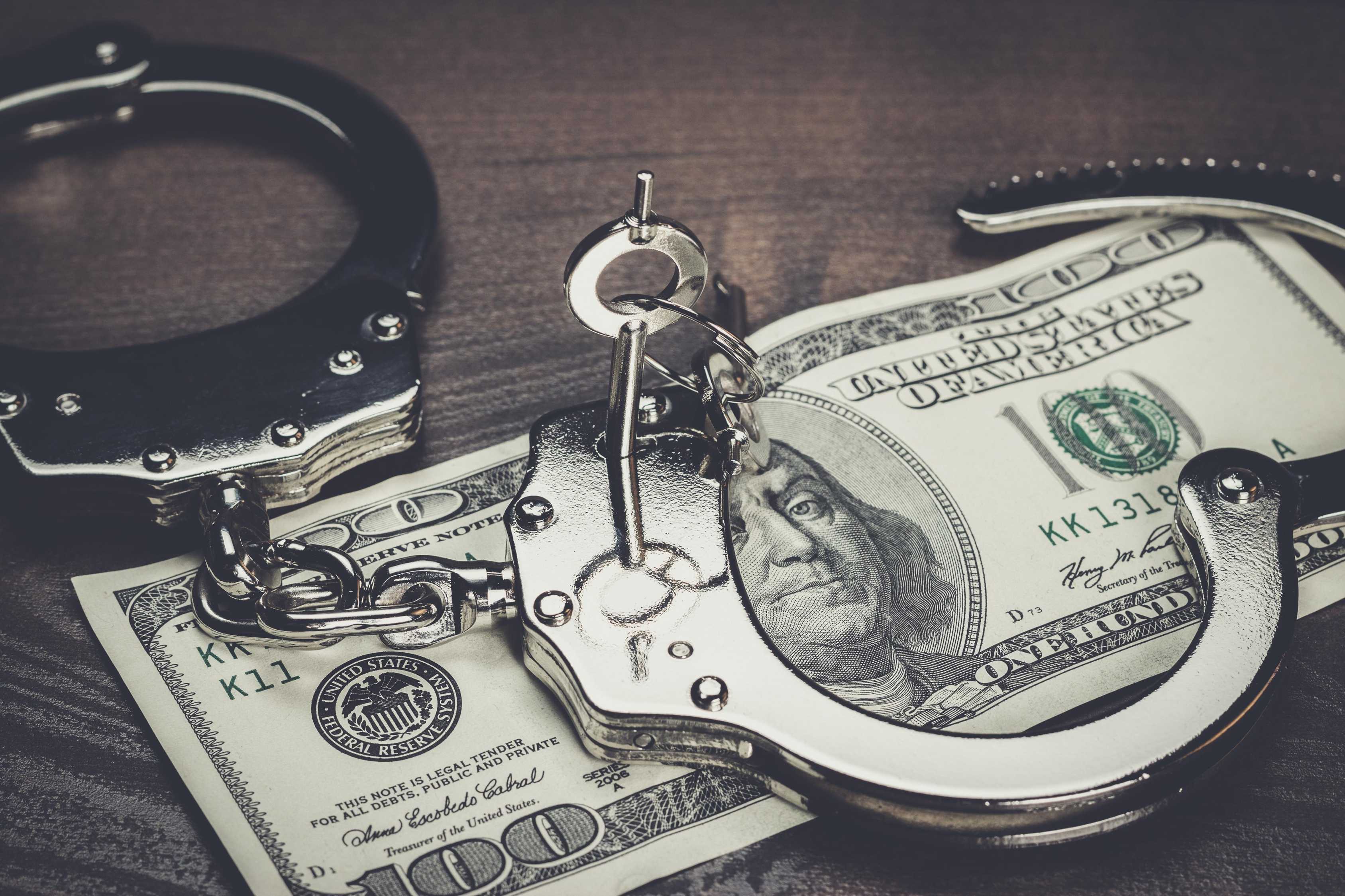 handcuffs and a hundred dollar bill