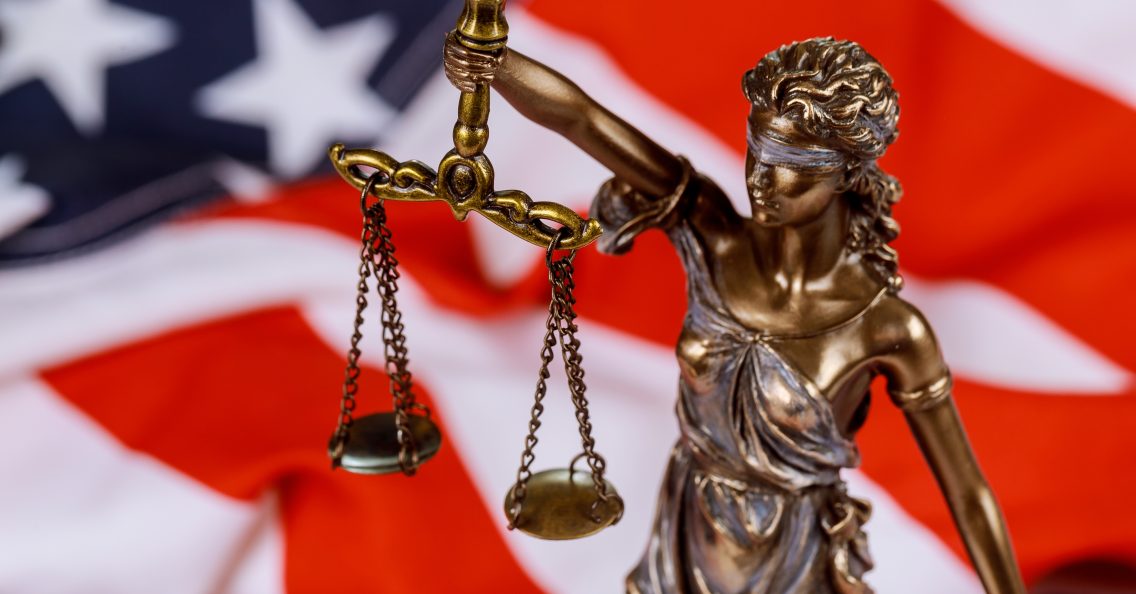 United States of America in Law and Justice statue of Lady Justice with USA flag