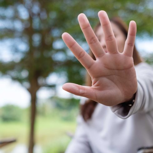 young woman outstretched her hand as if refusing