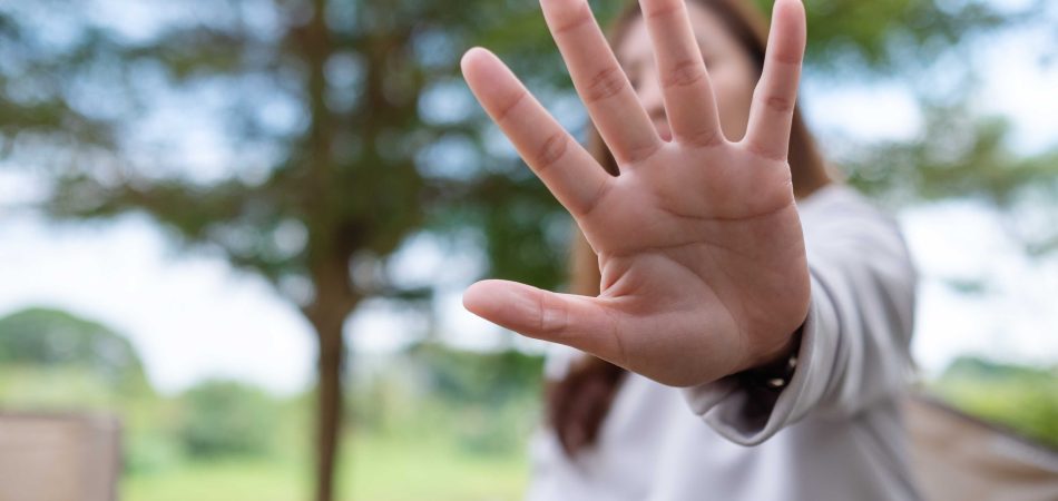 young woman outstretched her hand as if refusing