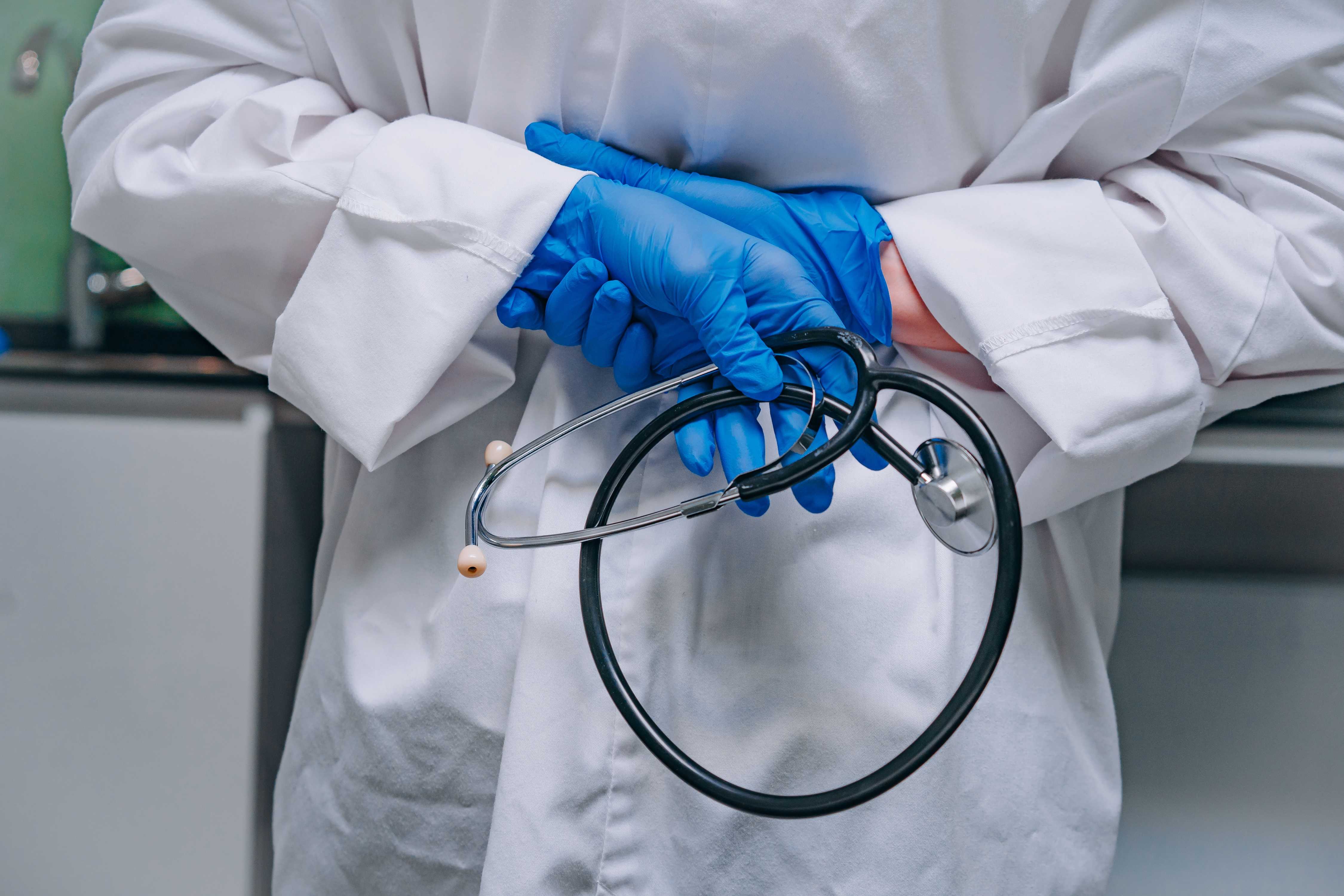 doctor in a white robe holding a phonendoscope