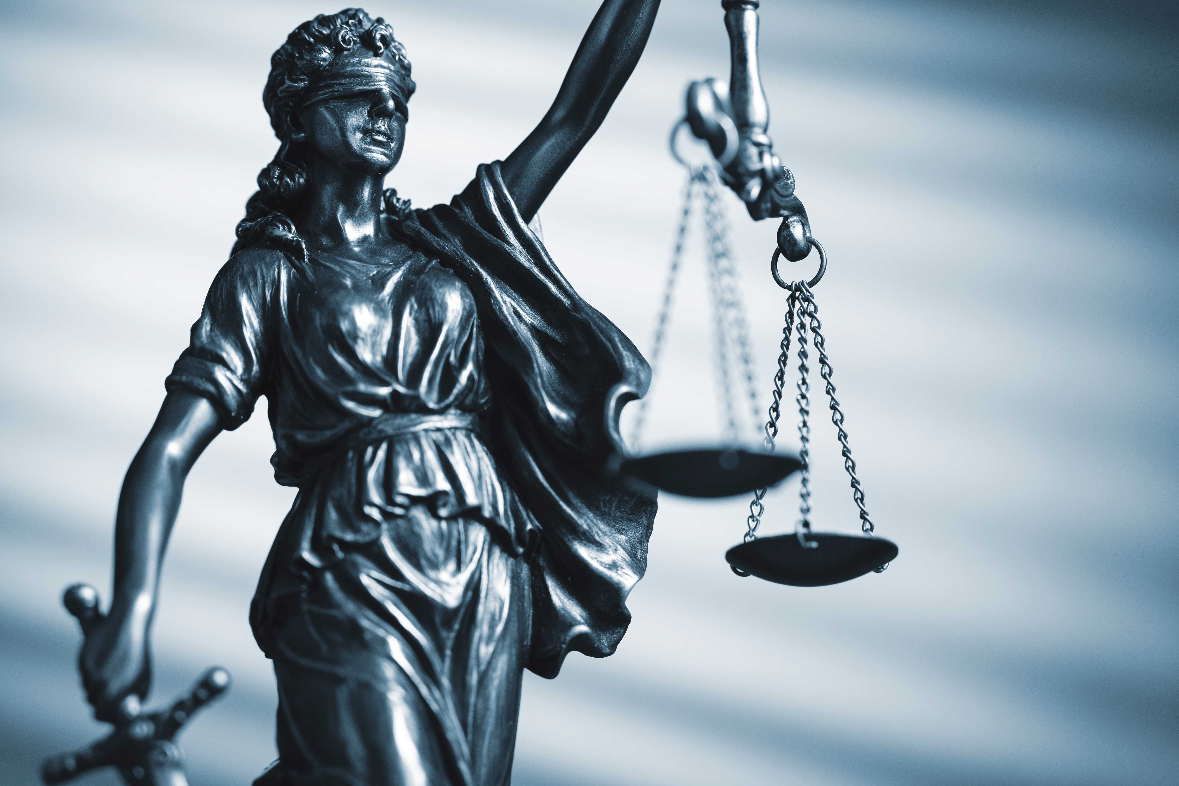 figure of justice holding scale and sword