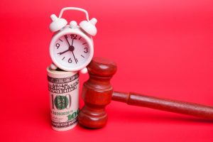 clock, gavel and money in a red background