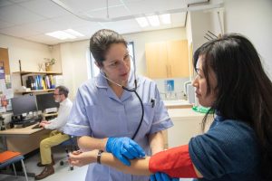 Nurse examining a patient after car accident