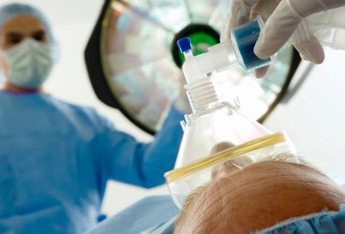 Close Up Shot Of An Assistant Positioning An Oxygen Mask Over A Patient With A Surgeon In The hospital - Ikerd Law Firm