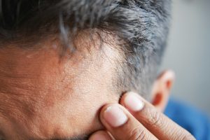 man having a chronic headeache