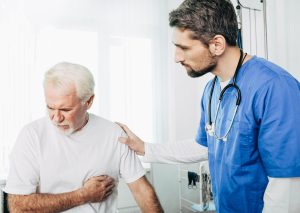 Senior patient suffering from heart attack . Doctor care about patient with heart pain