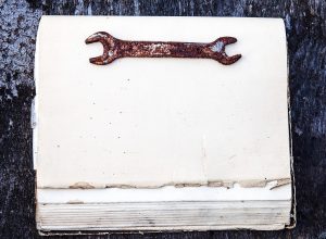 rusty wrench on a maintenance logbook